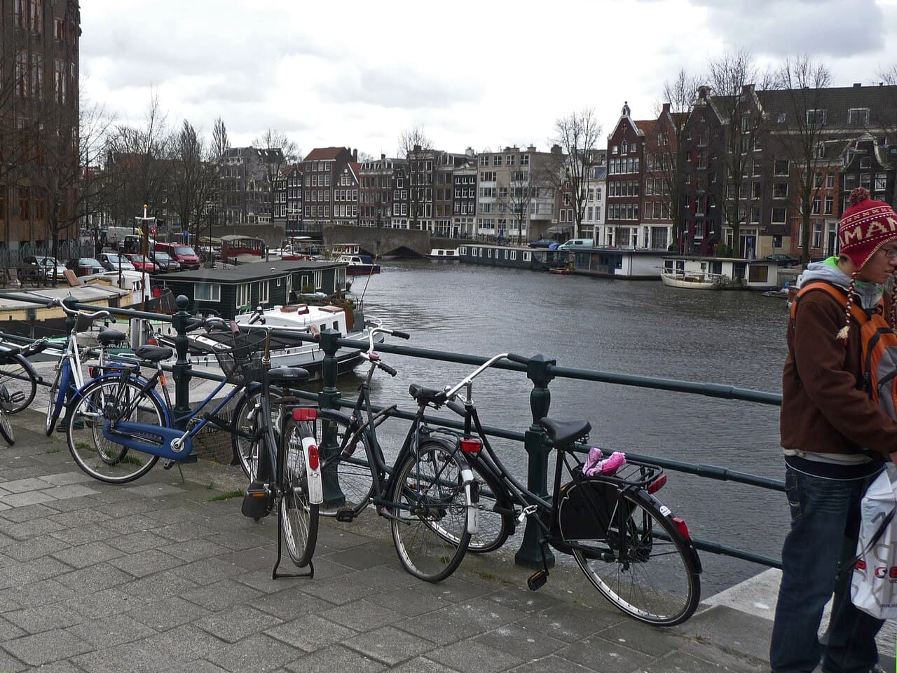 Cyclists crossing a canal bridge in Amsterdam morning light