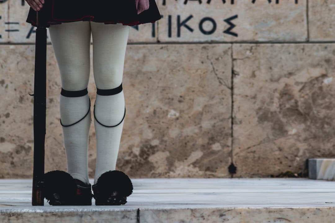 Evzone guards in traditional uniform performing the slow ceremonial changing of the guard