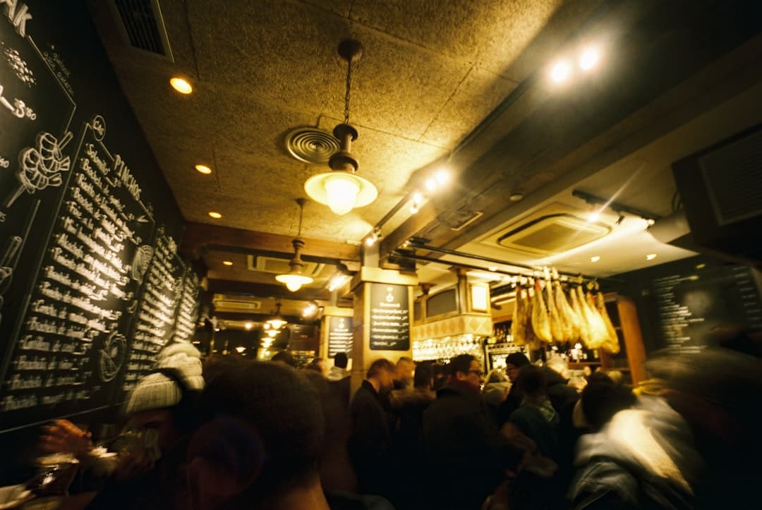 Counter crowded with toothpick-speared pintxos in a Poble-sec bar