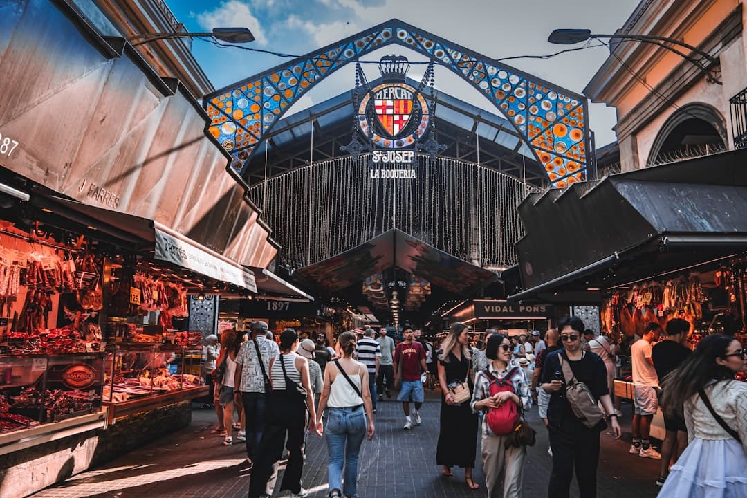 Colour-stacked produce and seafood counters inside La Boqueria market
