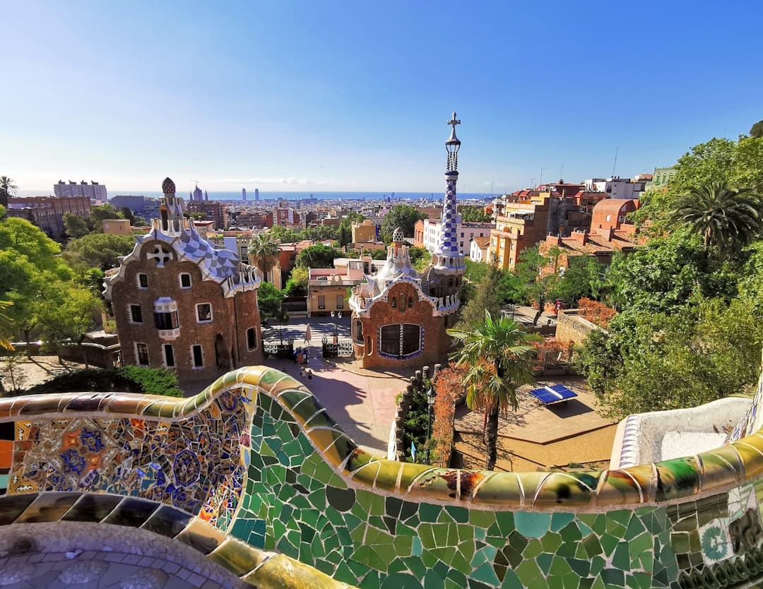 The mosaic serpentine bench of Park Güell with Barcelona and the sea beyond