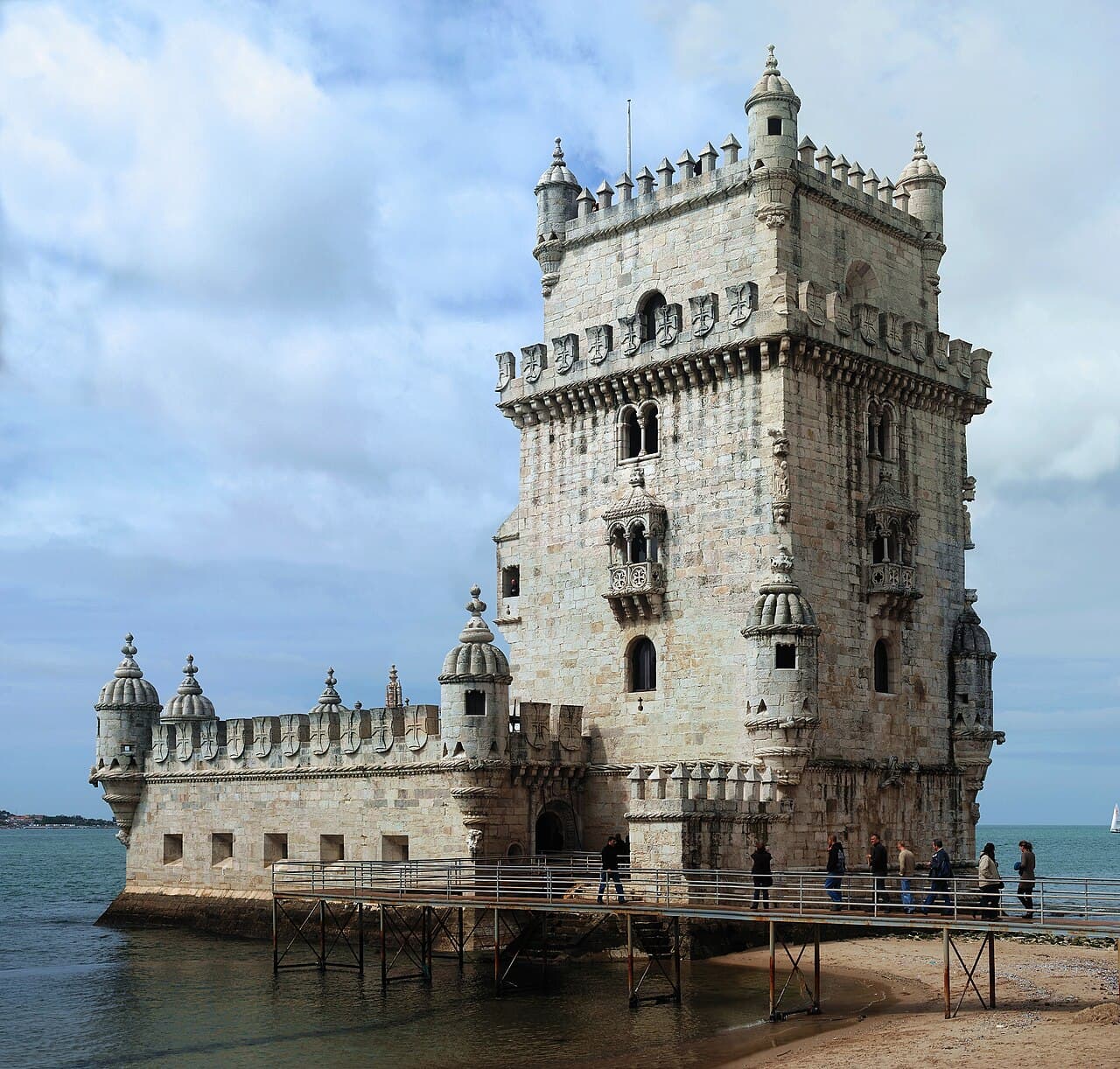 Belém Tower's carved stone turrets rising from the Tagus at golden hour