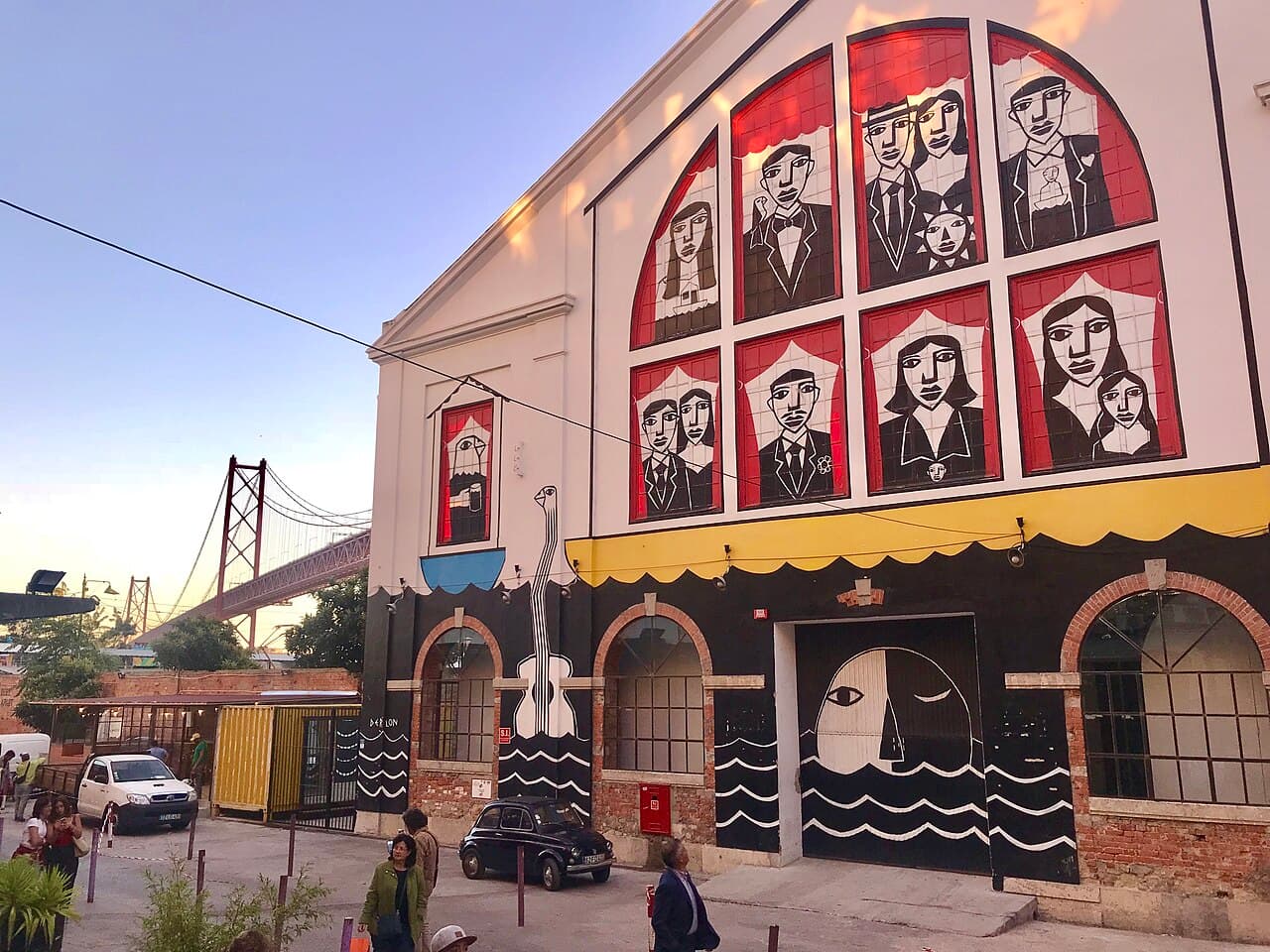 Street art and converted factory buildings at LX Factory under the 25 de Abril bridge