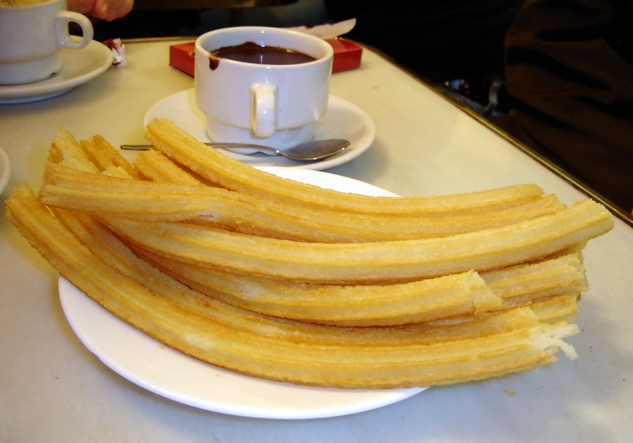 Churros with a cup of thick hot chocolate
