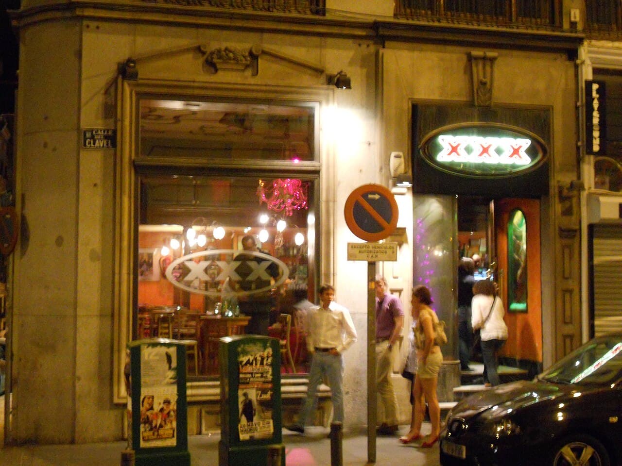 A busy bar-lined street at night in Malasaña, Madrid
