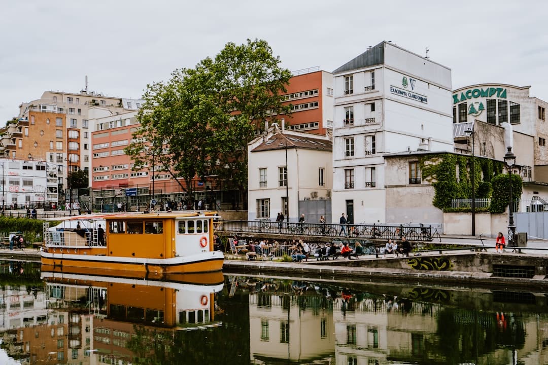 People sitting along the Canal Saint-Martin's banks at golden hour