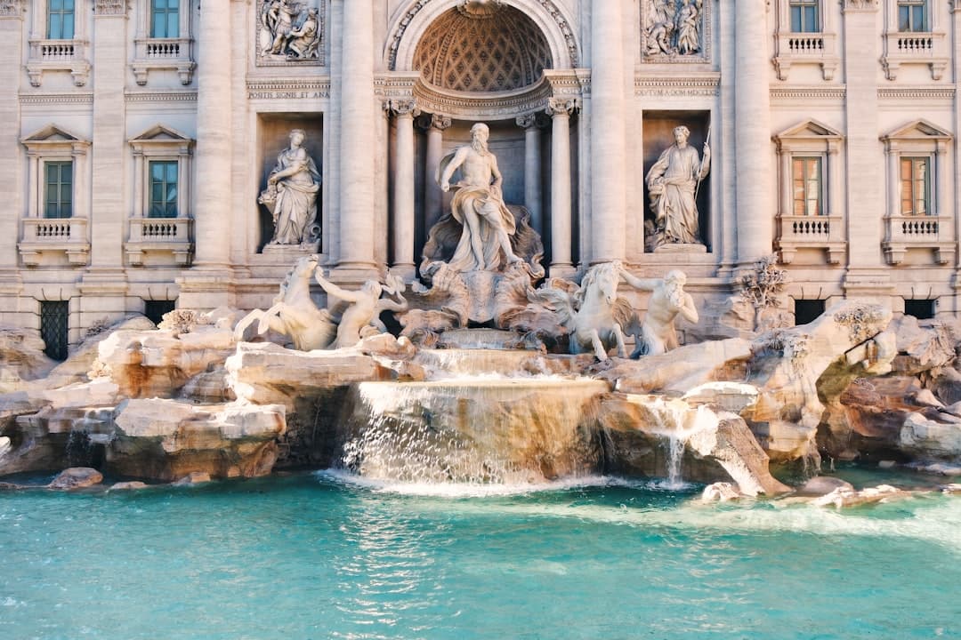The Trevi Fountain's sculpted figures and pool in soft early light