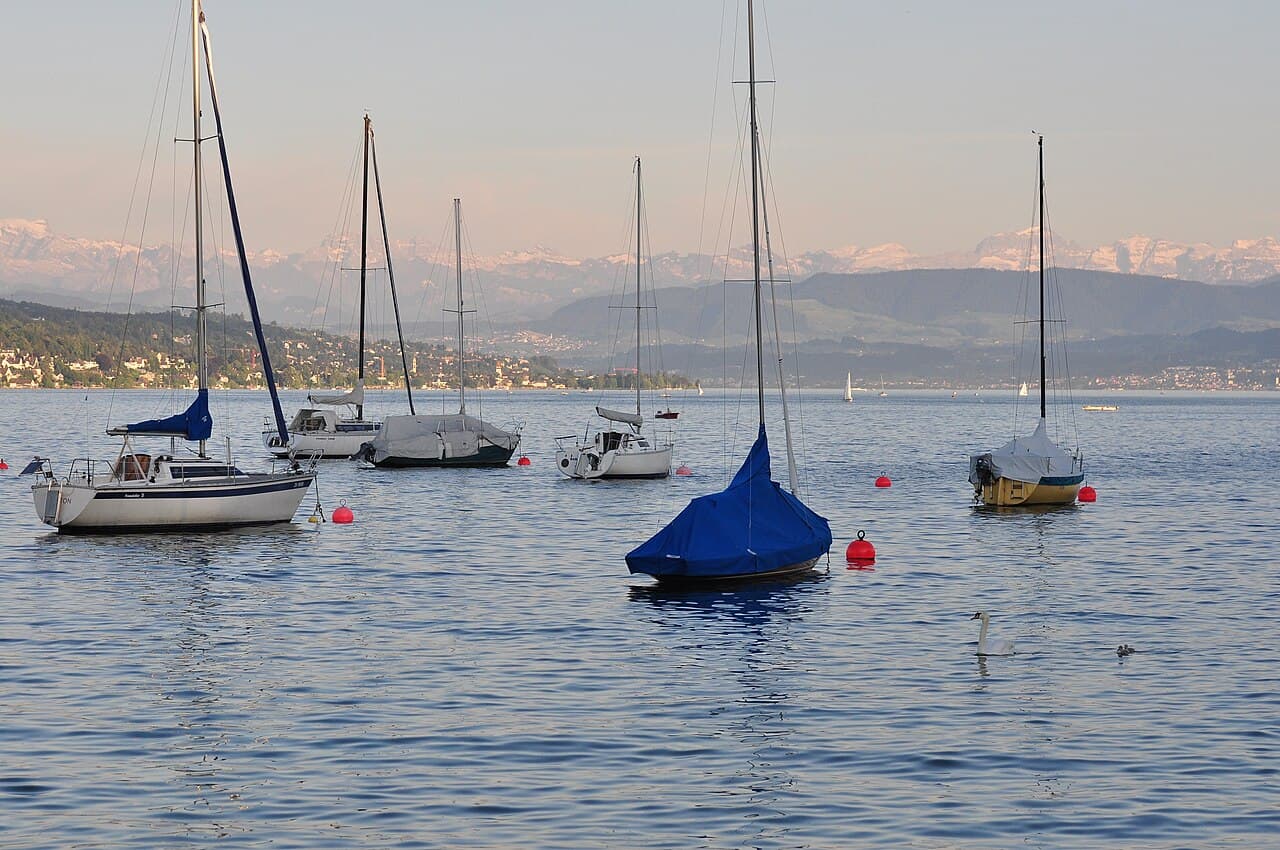A boat on Lake Zürich with the Alps beyond