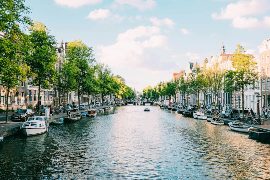 A canal lined with gabled houses and boats in the Nine Streets, Amsterdam