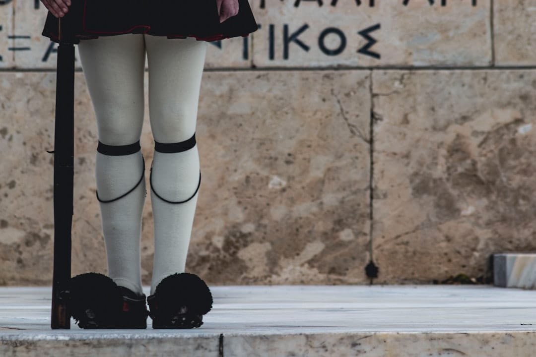 Evzone guards in traditional uniform performing the slow ceremonial changing of the guard