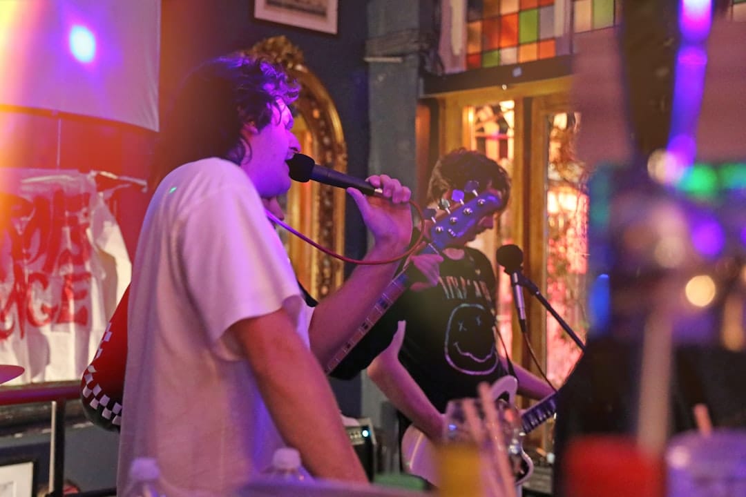 Musicians playing live rebetiko under coloured lights at an Athens venue