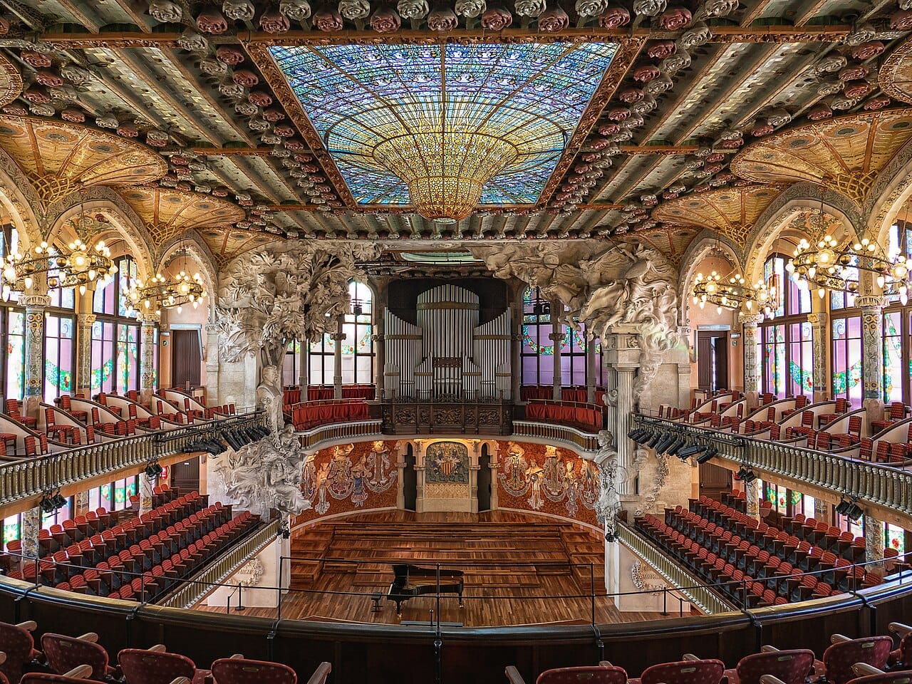 The ornate stained-glass interior of the Palau de la Música Catalana in Barcelona