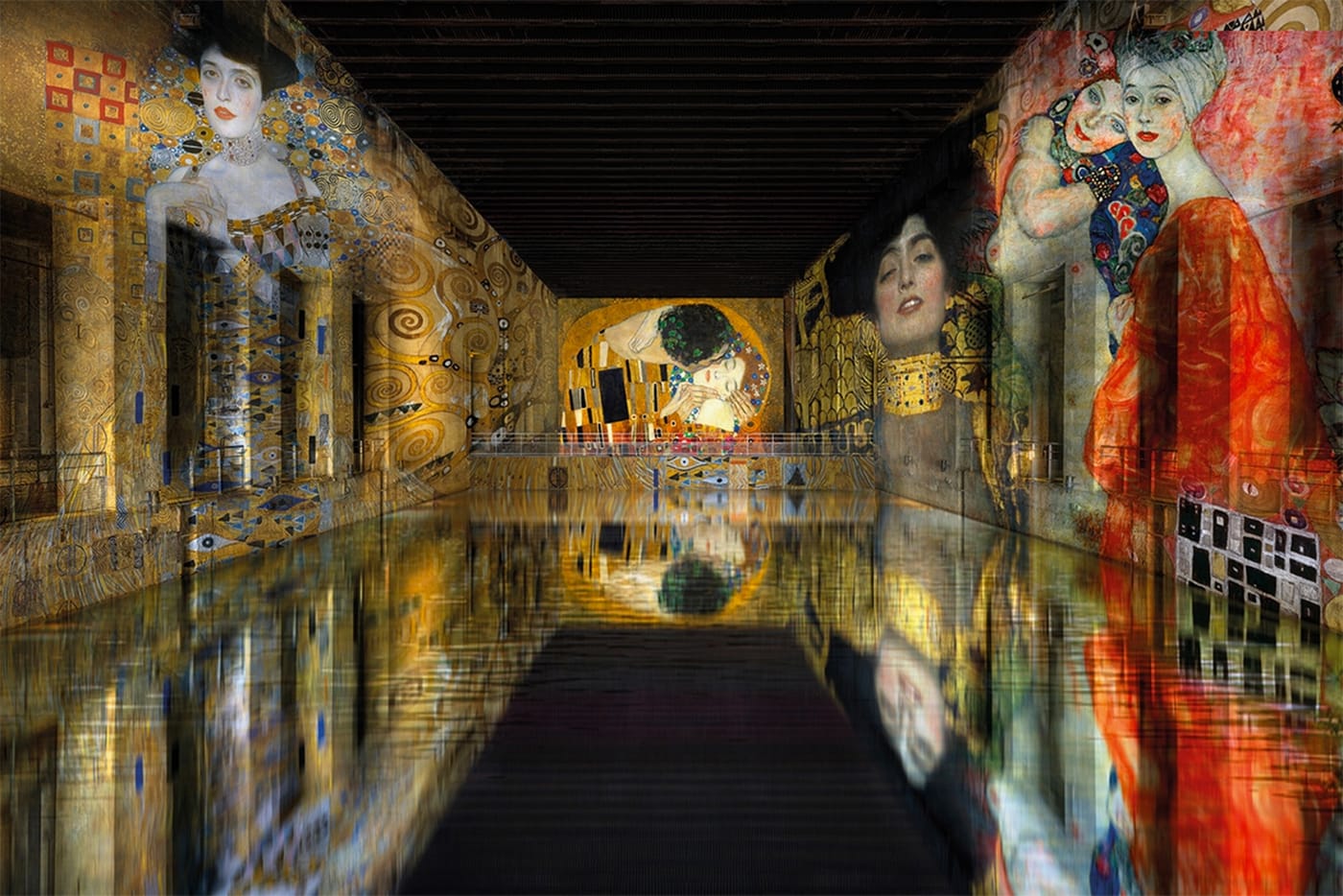 Projected artworks reflected in the water at the Bassins des Lumières in Bordeaux