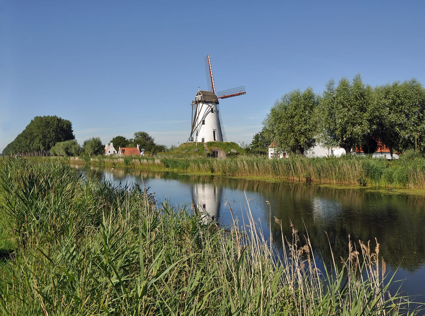 A windmill on the tree-lined canal to Damme near Bruges