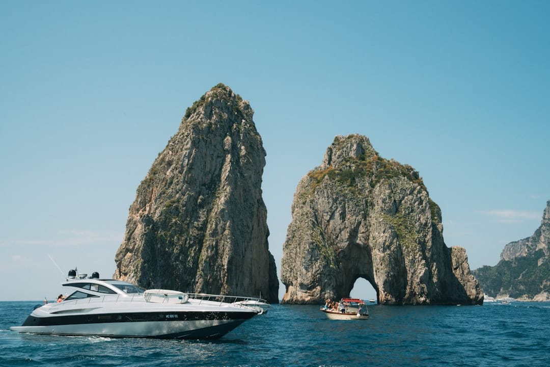The Faraglioni rocks and a boat, Capri