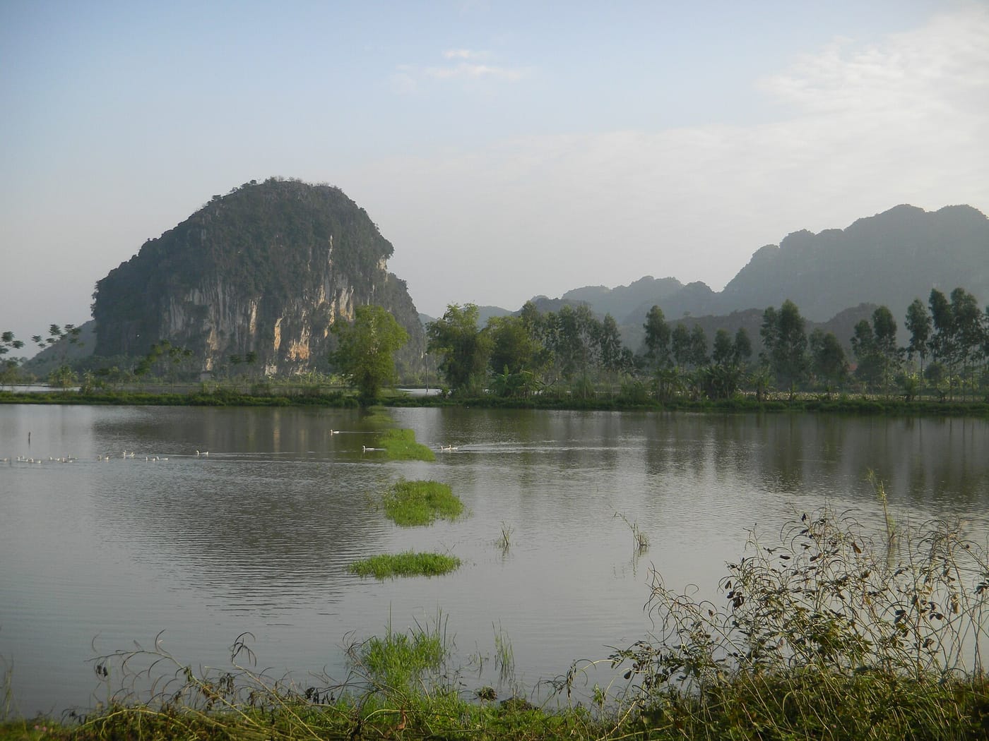 Karst peaks over a river and rice fields at Tam Coc, Ninh Binh