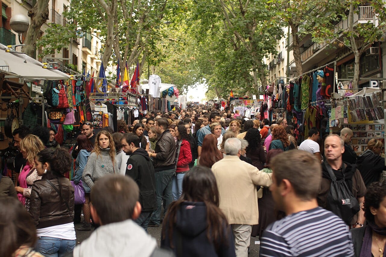 Stalls and crowds at the El Rastro flea market in Madrid