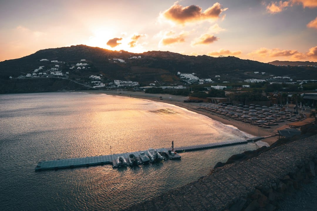 A cove and pier at sunset at Agios Ioannis beach on Mykonos
