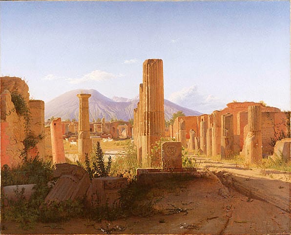Ruined columns of Pompeii with Mount Vesuvius behind