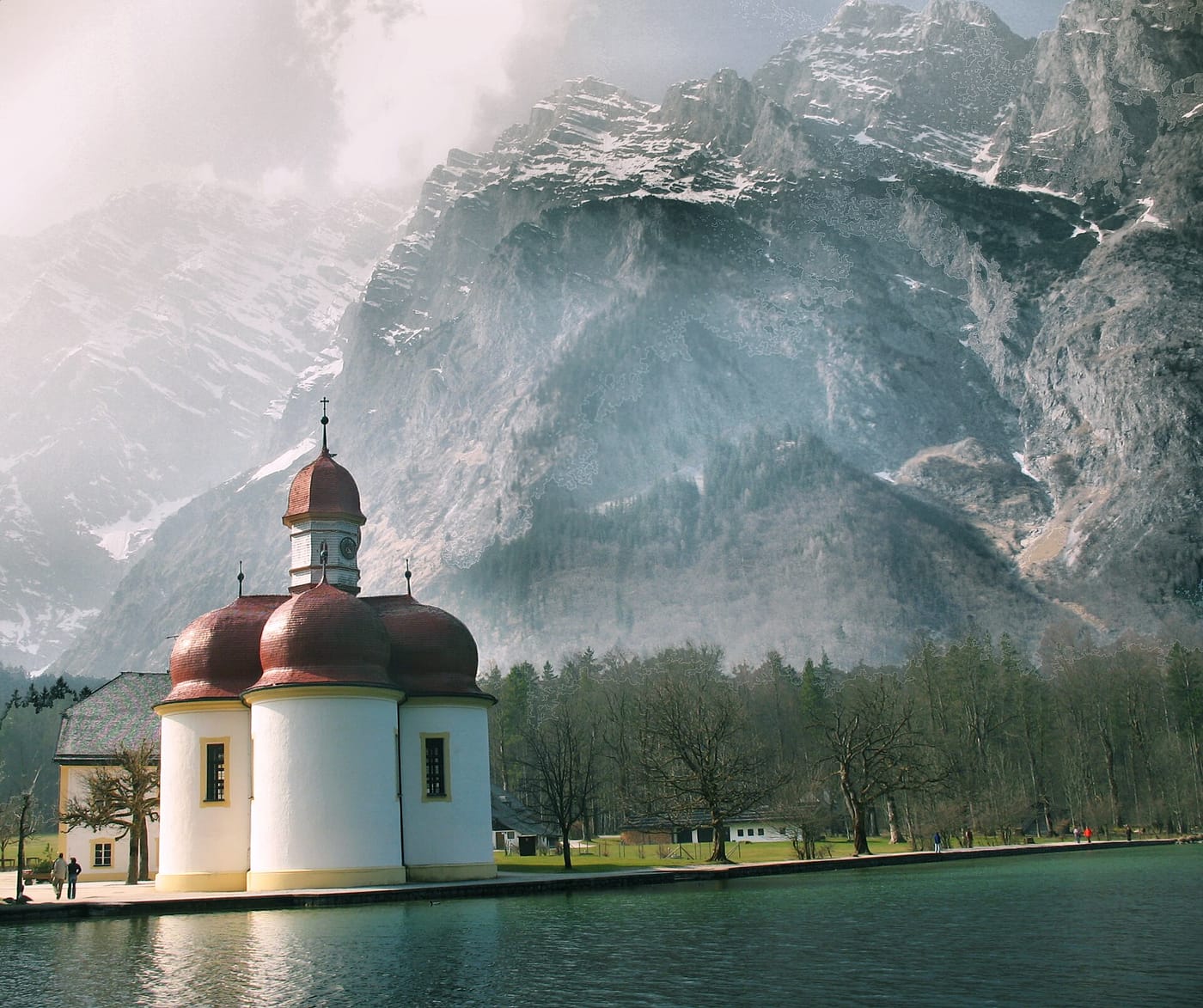 The red-domed St Bartholomä chapel on the Königssee below the cliffs