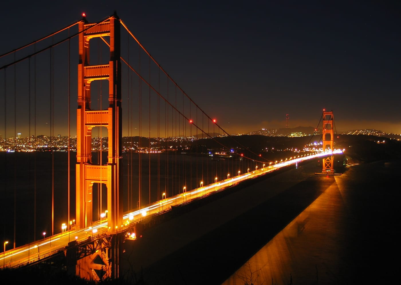 The Golden Gate Bridge at dusk seen from Baker Beach in San Francisco