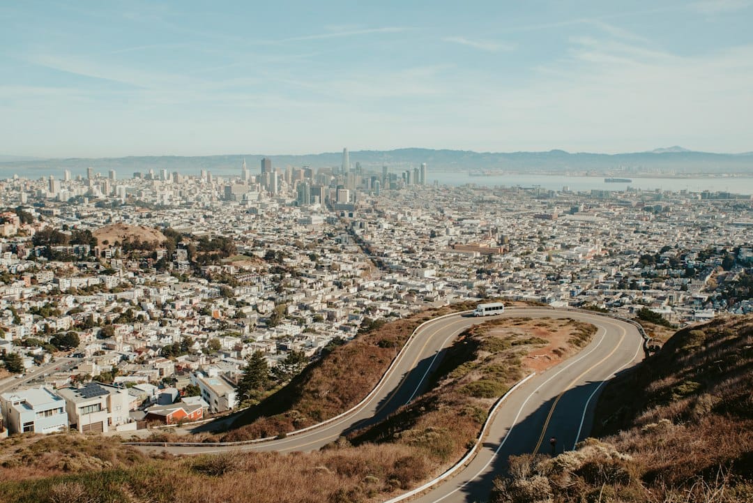 The San Francisco skyline and a winding road seen from Twin Peaks