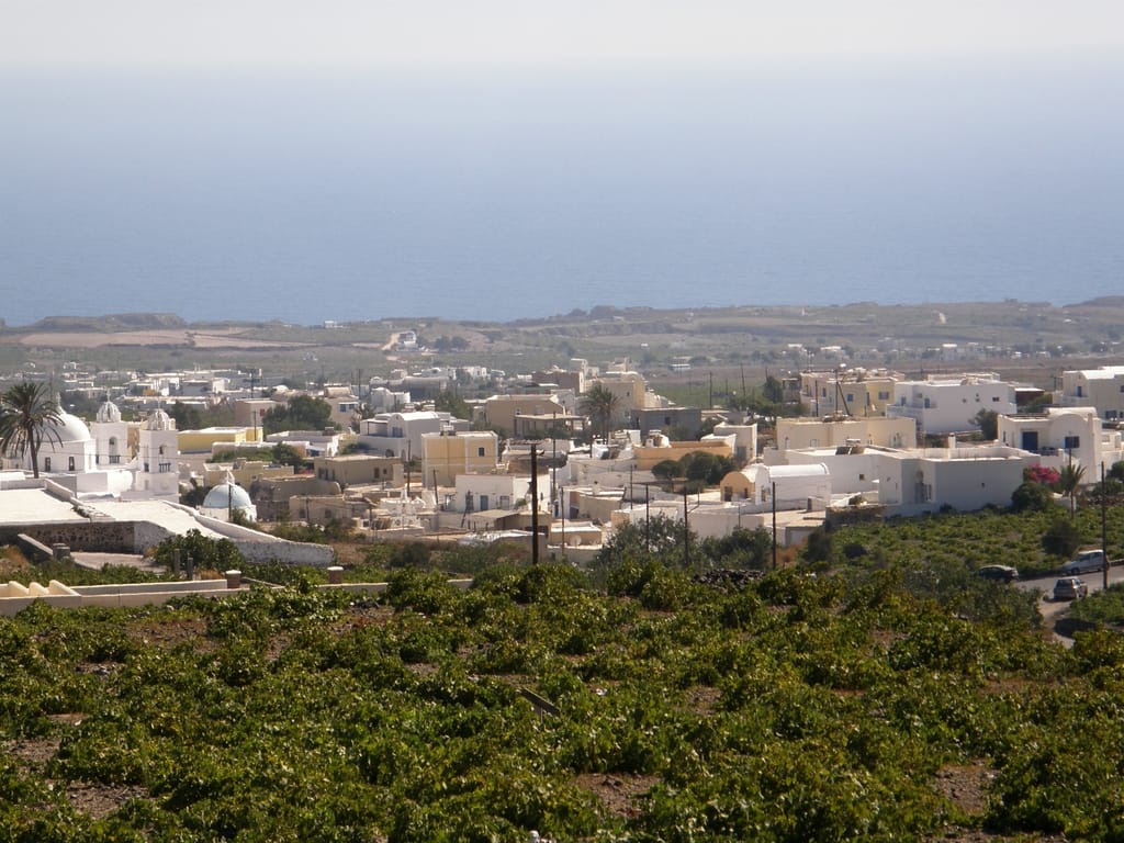 The bell towers and white houses of Megalochori village on Santorini