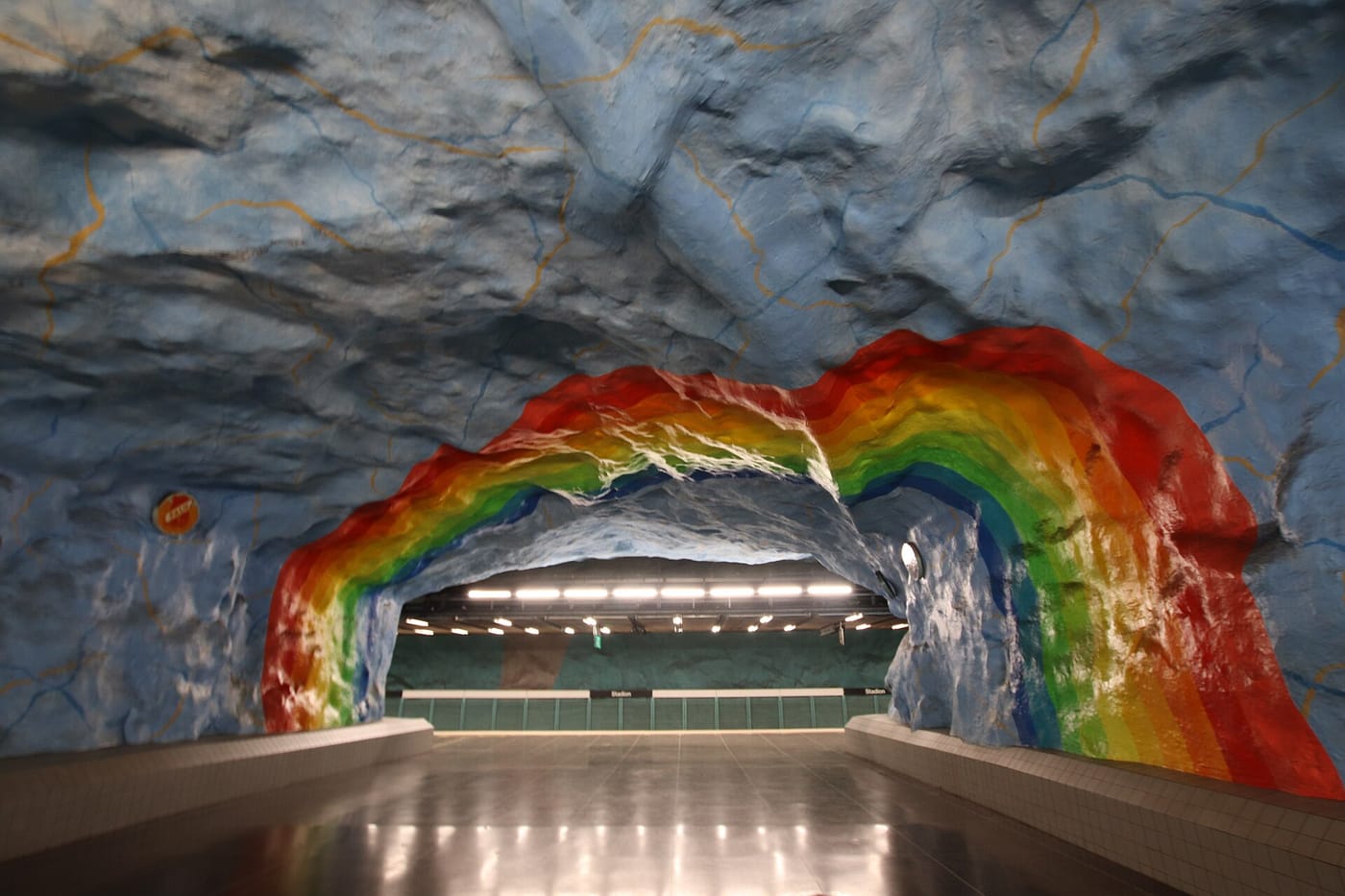 A rainbow-painted cave-like metro station in Stockholm