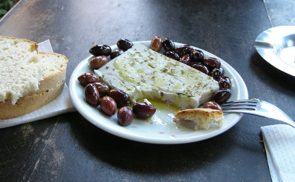 Tsipouro and meze on a Greek taverna table