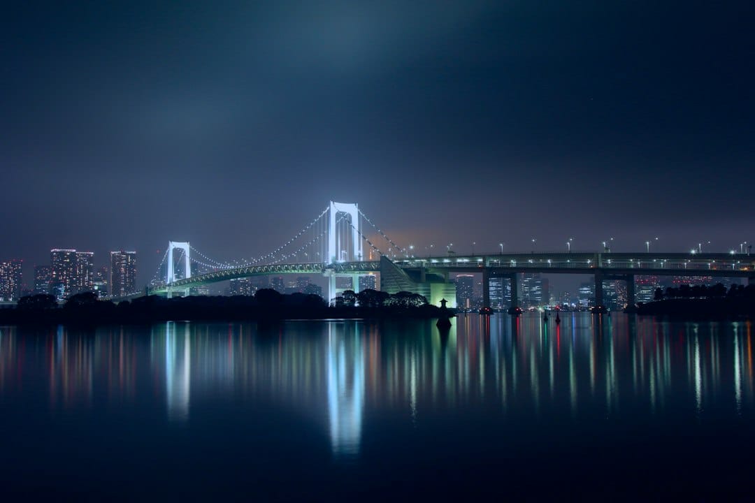 The Rainbow Bridge lit up at night over Tokyo Bay from Odaiba