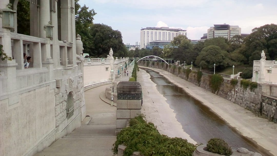 A river and bridge running through the leafy Stadtpark in Vienna