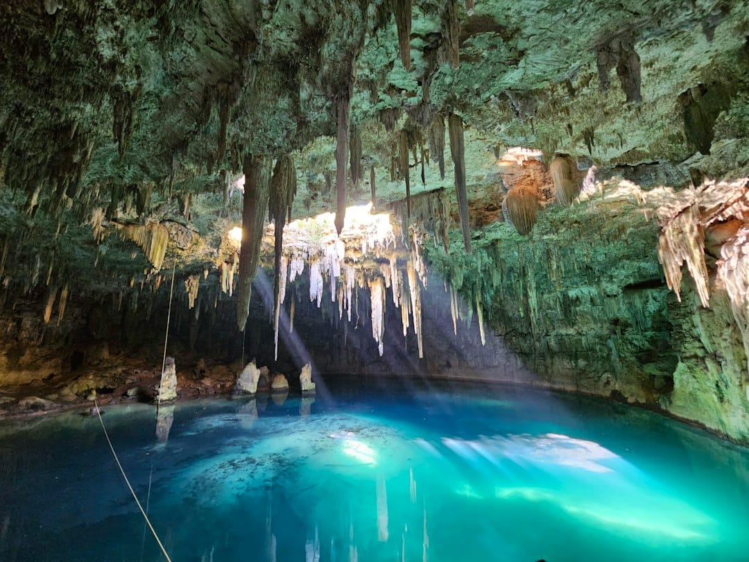 The glowing turquoise pool in the Kuza Cave in Zanzibar